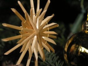 Ein selbstgebastelter Strohstern am Weihnachtsbaum